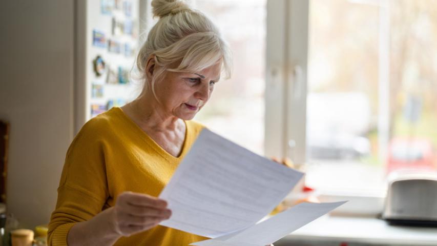 femme étudiant des contrats dans sa cuisine